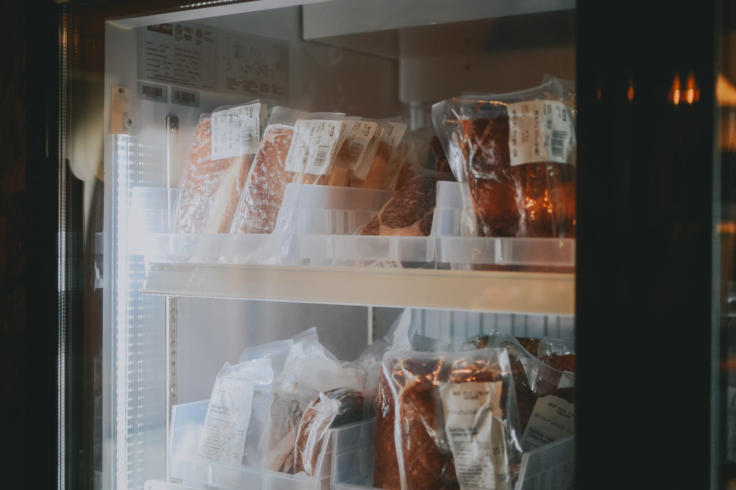 A freezer is stocked with assorted grass-fed beef cuts.