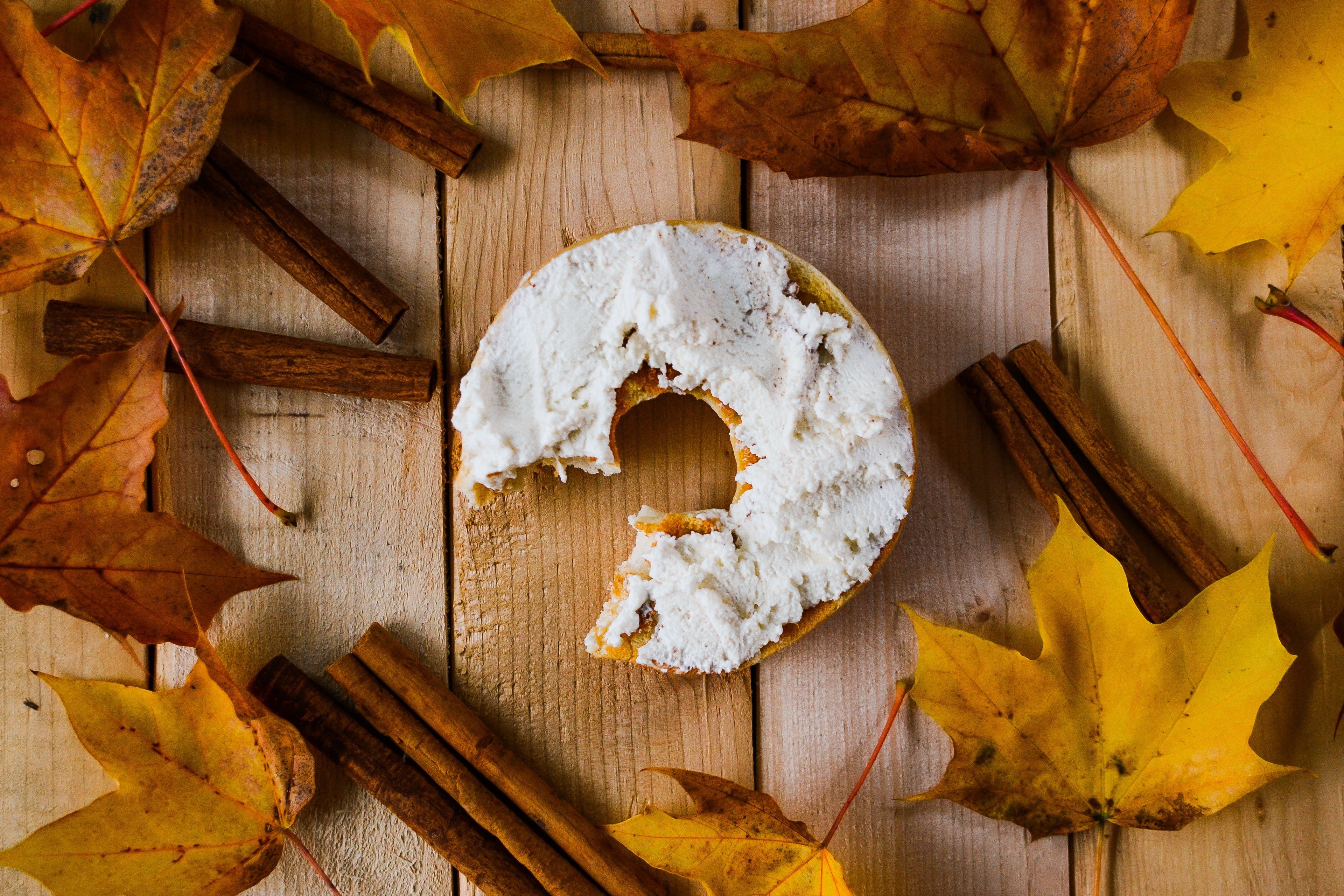 Maple Cinnamon Fromage Frais, served on a bagel and styled with cinnamon sticks and maple leaves.
