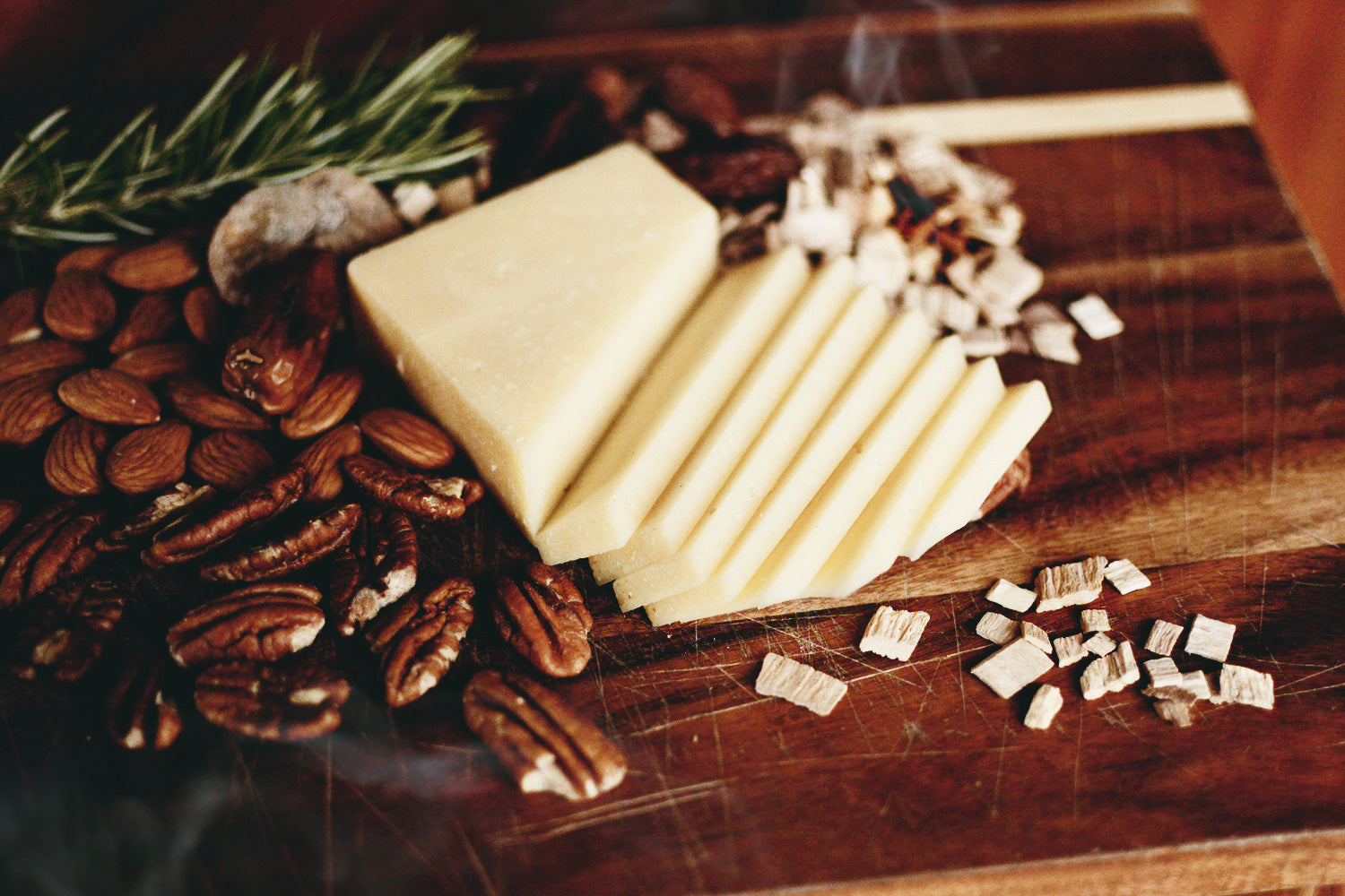 Old Smokey cheese styled with dried fruit, nuts, and wisps of smoke originating from wood chips