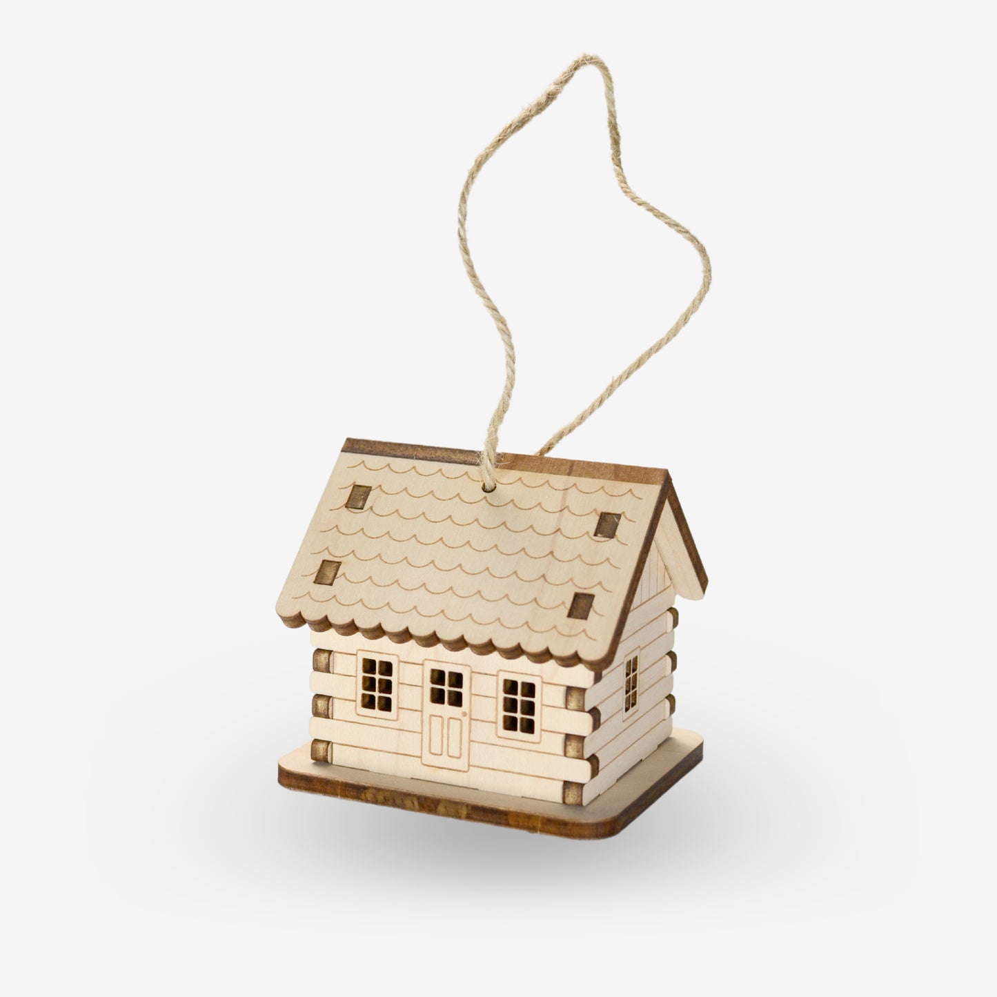 The assembled wood ornament is a charming log cabin. The front and back follow the long side of the roof and are engraved with horizontal log siding as well as two cut-out windows with a door in the center. Each gabled end is engraved the same, but with one window. The scalloped roof edge carries up to the roof top with engraved scalloped details. The assembly "tabs" for the four resemble interlocking logs.