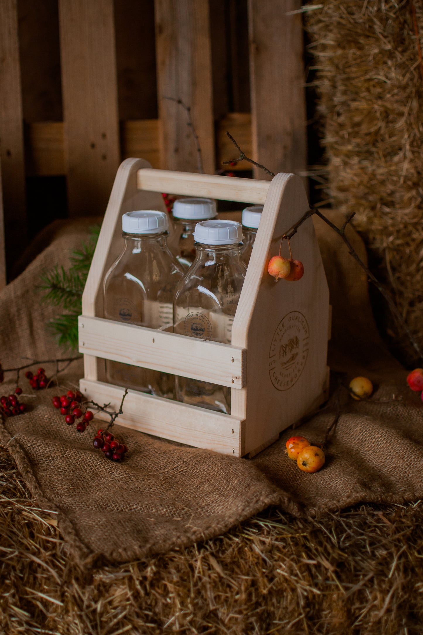 Medium sized wooden crate with glass bottles on a rustic background