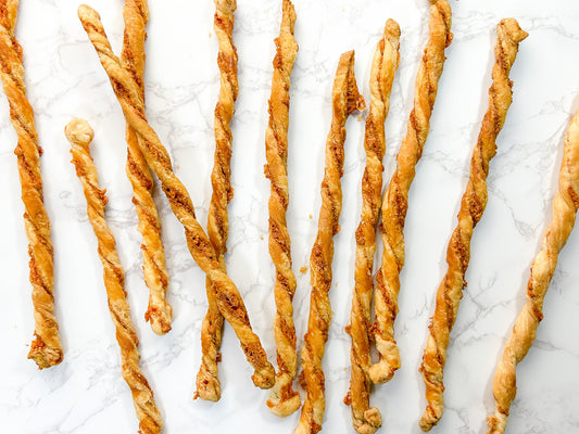 Long, slender "cheese straws" are baked until crunchy and served with dip