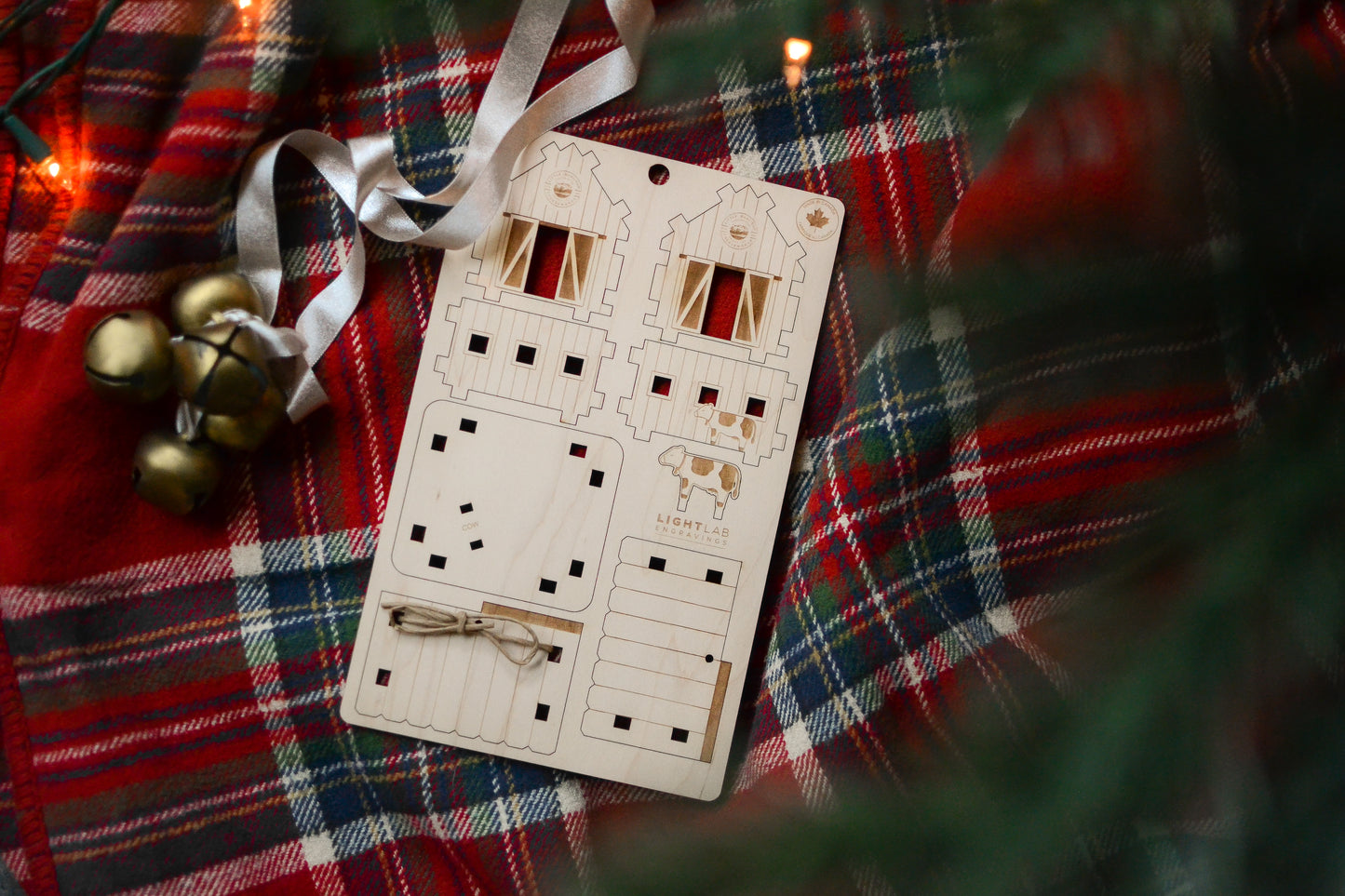 The un-assembled barn is styled under a Christmas tree.