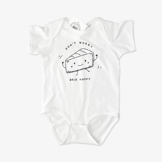 White baby onesie with black graphic of cheese saying don't worry brie happy