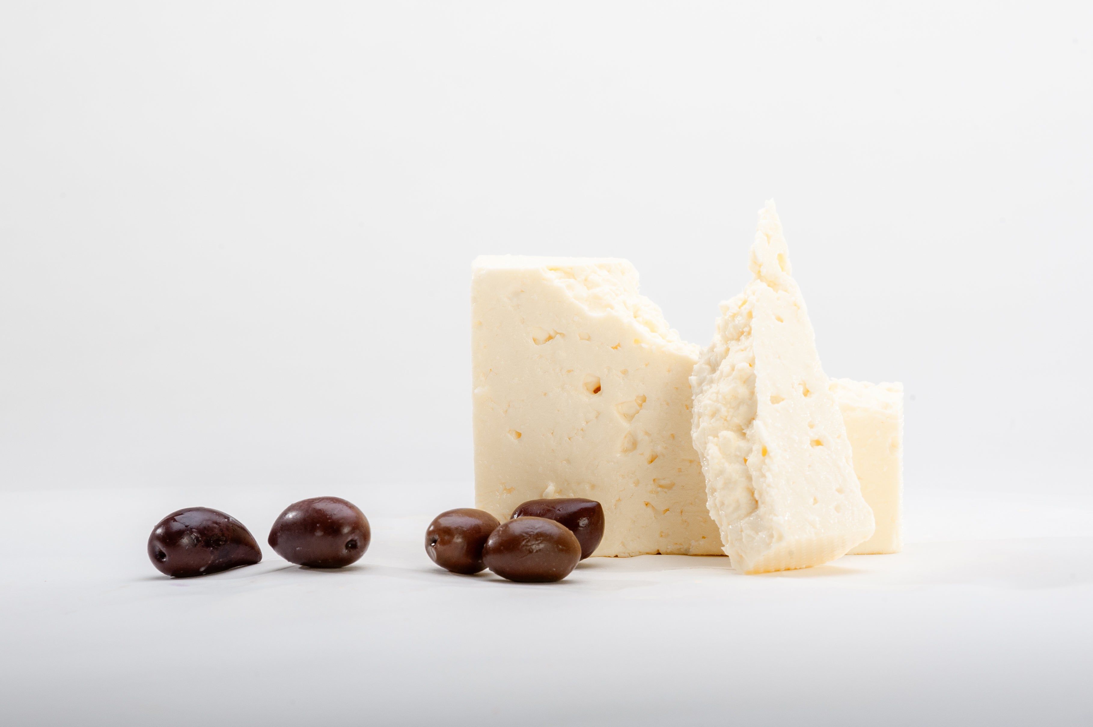 Feta cheese presented with black olives