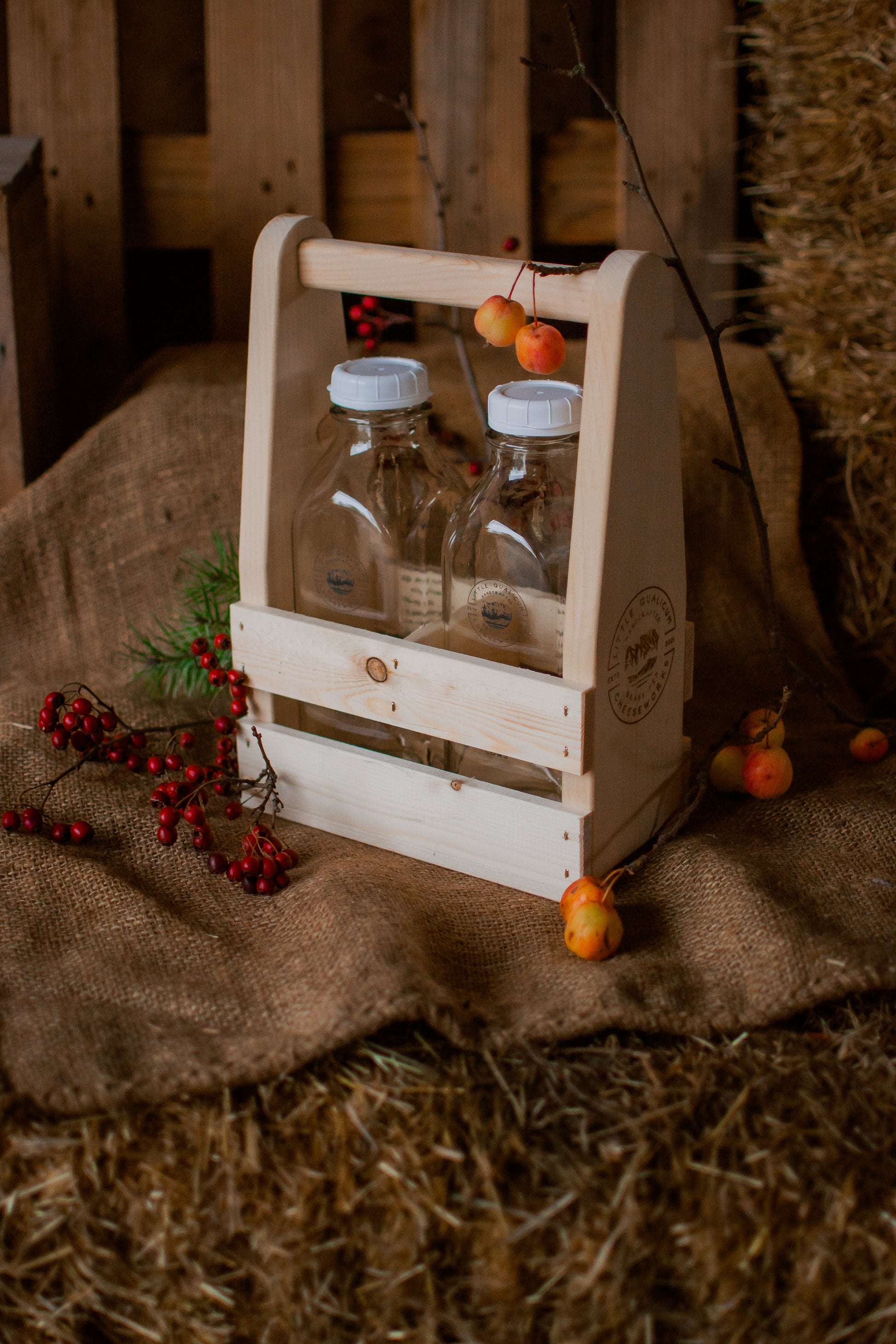 Small wooden crate with bottles on a rustic background