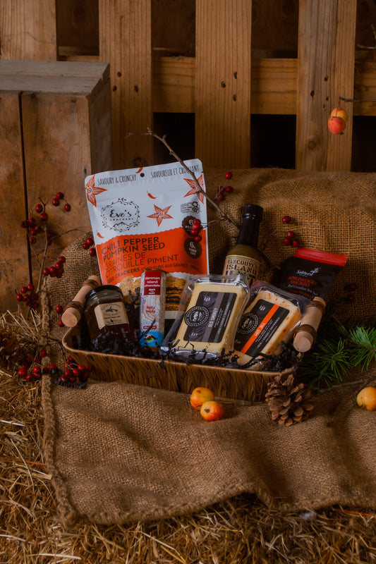 Gift basket with various local BC food items on a rustic wooden background