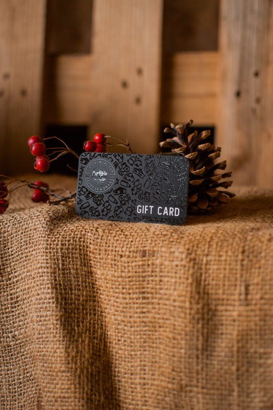 Gift card with decorative elements on a rustic wooden surface