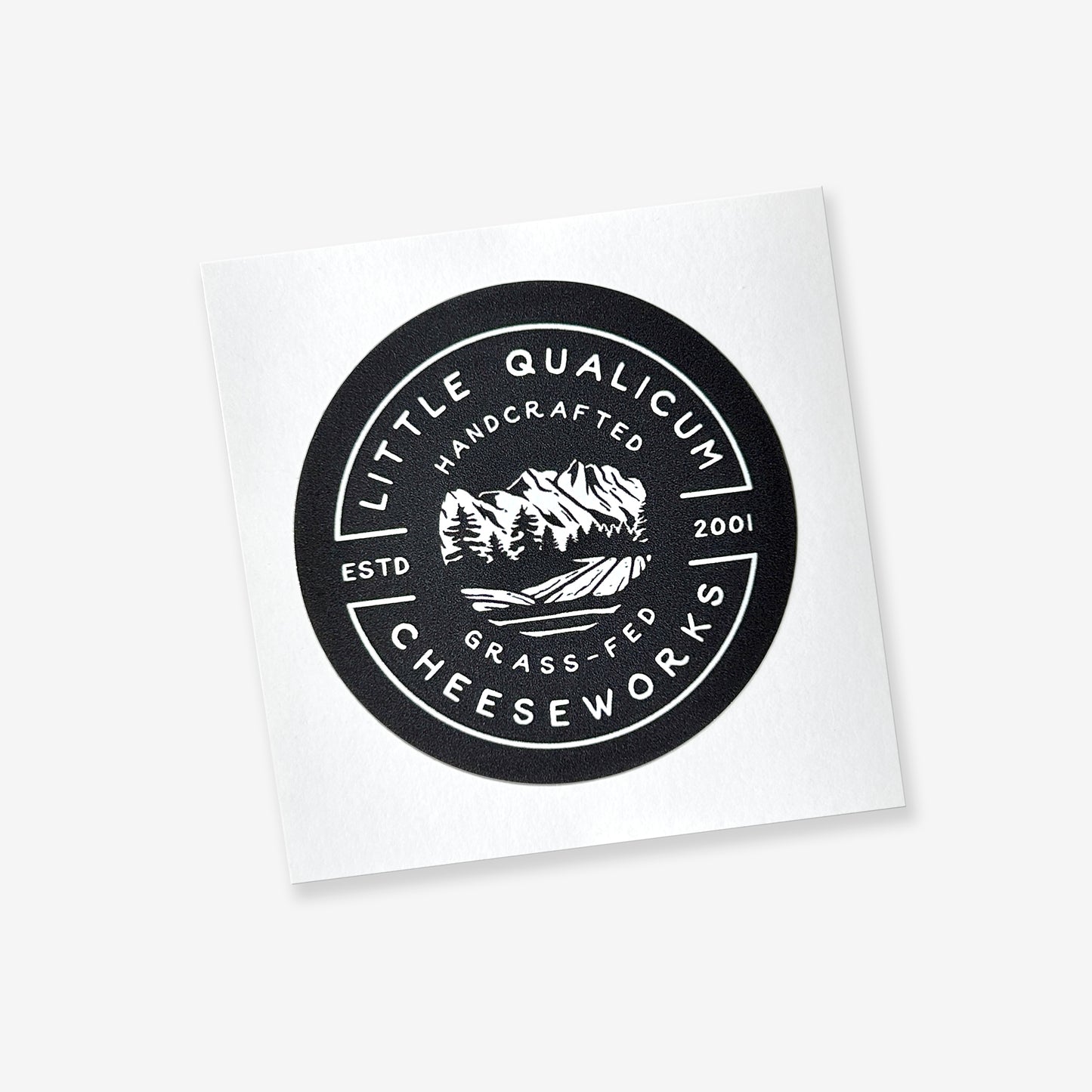 The round black sticker has the LQC logo in white. The sticker is on an easy-peel square back.