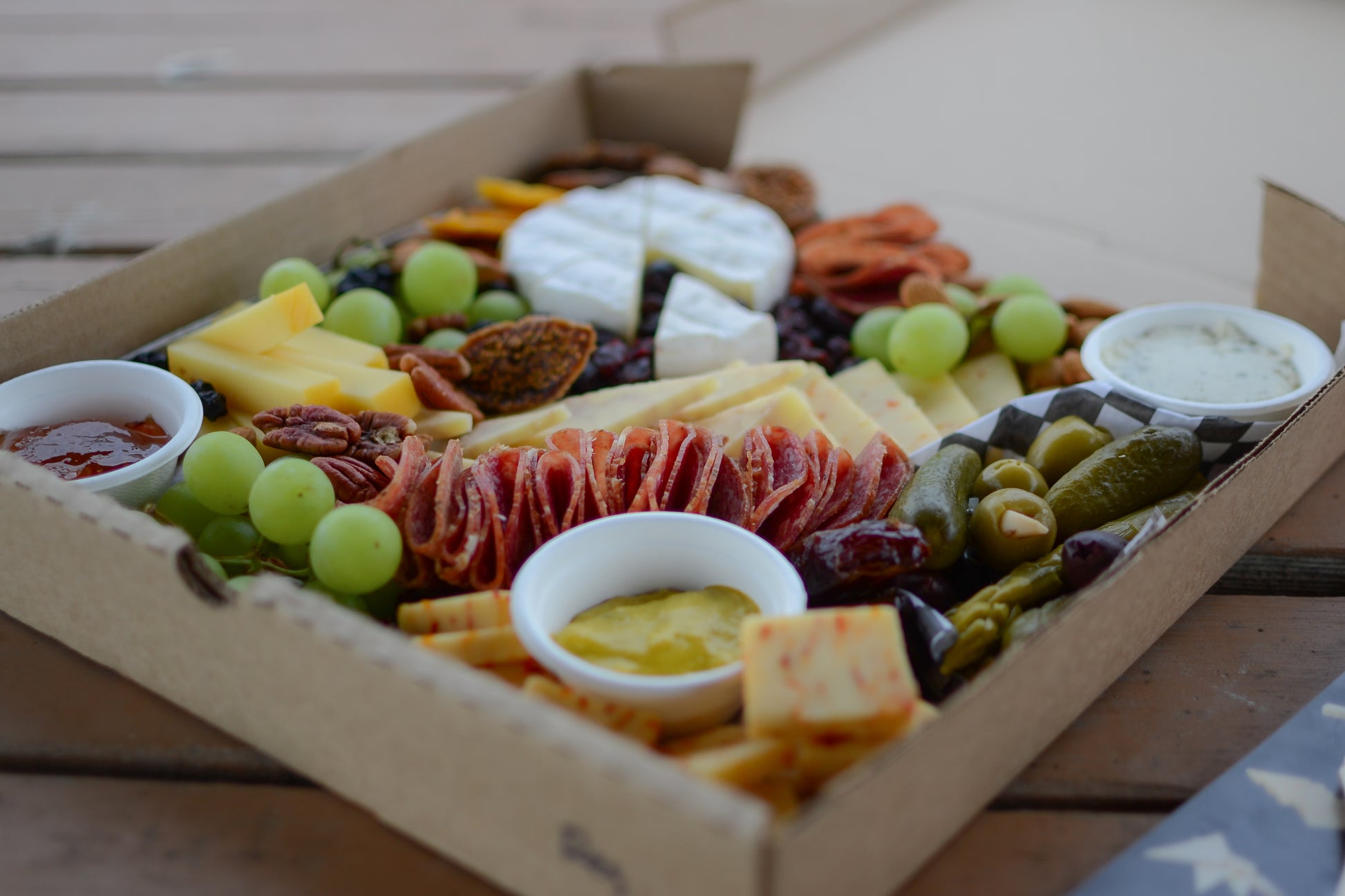 A large graze box on a picnic table, ready for a snack!