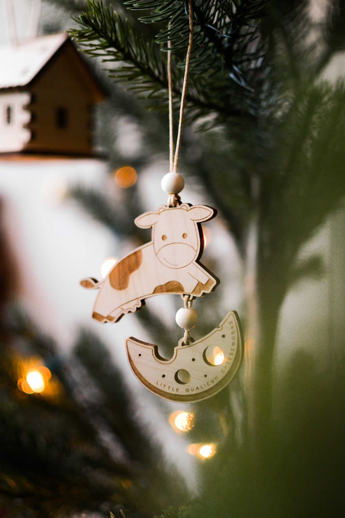 The wood ornament hangs on a Christmas tree.