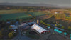 Video of farm from a bird's eye view, cheese processing, milk bottle, cow and grass