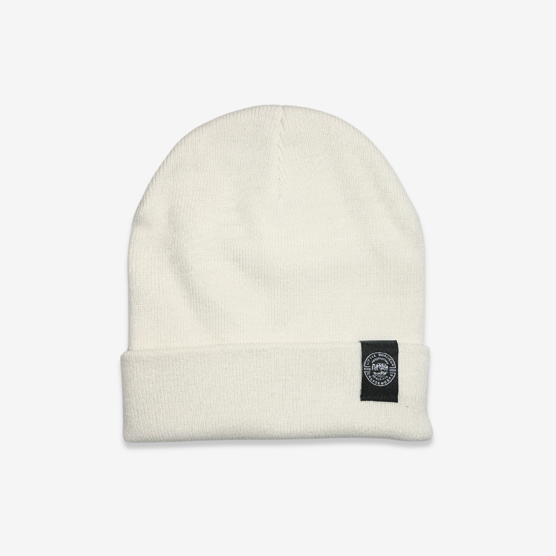 Cream coloured mid-weight knit toque with Little Qualicum Cheeseworks woven edge tag.