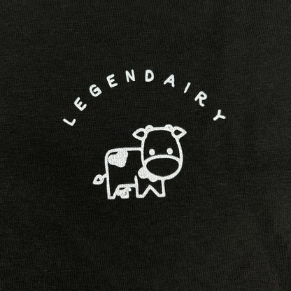Black t-shirt with white cow illustration and 'LEGENDAIRY' text on a black background